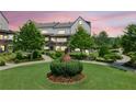 Well-maintained front lawn featuring beautiful statue and manicured landscaping for a pleasing aesthetic at 6930 Whitman Walk, Alpharetta, GA 30005
