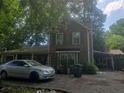 Two-story home with wood siding and a car parked out front at 1383 Natchez Sw Trce, Marietta, GA 30008