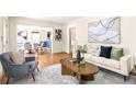 Open living room with hardwood floors, stylish decor, and a view into the dining area at 217 Rockyford Ne Rd, Atlanta, GA 30317