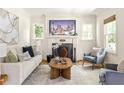 Bright living room featuring a fireplace, comfortable seating, and natural light at 217 Rockyford Ne Rd, Atlanta, GA 30317
