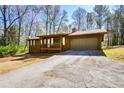 View of the home's exterior featuring a two-car garage and charming front porch at 4800 Timber Ridge Dr, Douglasville, GA 30135