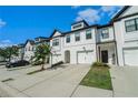 Picture showcases the townhome's facade, manicured lawn, and convenient two-car garage at 160 Auburn Gate Ln, Auburn, GA 30011