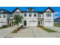 Charming exterior view showcasing the white painted brick and modern design of the townhome at 160 Auburn Gate Ln, Auburn, GA 30011