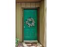 Inviting entry with a green door and wreath, creating a warm welcome to the property at 3907 Cedar Cir, Tucker, GA 30084