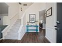 Bright foyer with staircase, hardwood floors, and stylish decor at 5010 Amber Leaf Dr, Roswell, GA 30076