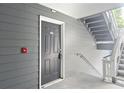 Apartment entryway featuring a gray door with unit number and nearby stairs at 5207 Santa Fe Pkwy, Sandy Springs, GA 30350