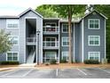 Exterior of a three-story apartment building with gray siding and white trim at 5207 Santa Fe Pkwy, Sandy Springs, GA 30350