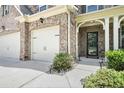 Close-up of the inviting front entrance with a decorative door and a well-manicured garden at 5696 Walnut Mill Ln, Powder Springs, GA 30127