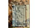 Close-up of a white security screen door with vertical bars, brick, and the number 106 at 106 Plantation Dr, Clarkston, GA 30021