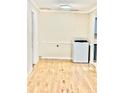 Laundry room with washer, fresh paint, and laminate flooring at 106 Plantation Dr, Clarkston, GA 30021