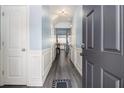 Inviting entryway with wood flooring, wainscoting, and a view into the open-concept living space at 1232 Candler Ct, Morrow, GA 30260