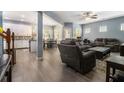 Open-concept living room featuring wood floors, modern furnishings, and seamless flow to the kitchen at 1232 Candler Ct, Morrow, GA 30260