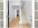 Bright foyer showcases hardwood floors and a staircase leading to the upper level at 4221 Rogers Creek Ct, Duluth, GA 30096