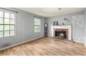 Bright living room features a brick fireplace, wood floors, and natural light at 4672 Satellite Blvd, Duluth, GA 30096