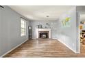 Bright living room features a brick fireplace, wood floors, and natural light at 4672 Satellite Blvd, Duluth, GA 30096