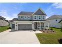 Charming home featuring gray siding, white trim, and a spacious driveway leading to a convenient attached garage at 916 Gambino Trce, Peachtree City, GA 30269