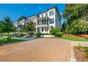 Paver driveway and street view of modern townhomes in a manicured community at 100 Villa Magnolia Ln, Alpharetta, GA 30009