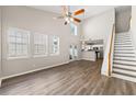 Bright living room with high ceilings, modern ceiling fan, lots of windows, and hardwood floors at 486 Windcroft Nw Cir, Acworth, GA 30101