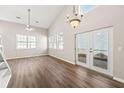 Bright living room with high ceilings, modern ceiling fan, hardwood floors, and access to the back patio at 486 Windcroft Nw Cir, Acworth, GA 30101