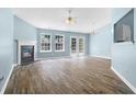 Bright living room featuring a fireplace, hardwood floors, and double doors to the outside at 110 Holly Mill Village Dr, Canton, GA 30114