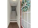 Inviting foyer features a staircase, hardwood floors, and a decorative wreath on the front door at 2227 Foley Park St, Snellville, GA 30078