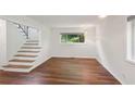 Bright living room with hardwood floors, view of staircase and a modern light fixture at 3282 Leslie Court Northeast Ne Ct, Atlanta, GA 30345