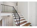 Interior staircase with metal railing, featuring hardwood treads and a neutral color scheme at 3282 Leslie Court Northeast Ne Ct, Atlanta, GA 30345