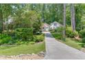 Beautiful view of the house with well-maintained front yard, gorgeous landscaping, and a long driveway at 3219 Parkridge Crescent, Chamblee, GA 30341