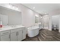 Luxurious primary bathroom with double vanity, soaking tub, and glass shower at 775 Hadley Ne Ln, Marietta, GA 30068