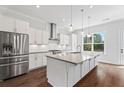 Modern kitchen featuring stainless steel appliances, a large island, and stylish pendant lighting at 775 Hadley Ne Ln, Marietta, GA 30068