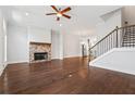 Spacious living room with hardwood floors, a fireplace, and staircase at 775 Hadley Ne Ln, Marietta, GA 30068