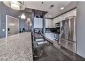 Bright kitchen featuring stainless steel appliances, granite counters, modern sink fixtures, and overhead lighting at 361 17Th St # 1121, Atlanta, GA 30363