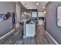 Kitchen area with white cabinets, stainless steel appliances, breakfast bar, and hardwood flooring at 361 17Th St # 1121, Atlanta, GA 30363