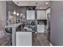 Stylish kitchen features stainless steel appliances, bar seating, granite countertop, and pendant lighting at 361 17Th St # 1121, Atlanta, GA 30363