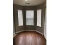 Bright breakfast nook area illuminated by three large windows, with vinyl floors and a door to the kitchen at 776 Crestside Ct, Austell, GA 30168