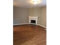 Cozy living room with hardwood floors and a traditional fireplace, perfect for relaxing and entertaining at 776 Crestside Ct, Austell, GA 30168