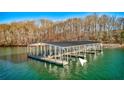 Lake house with boat dock, perfect for enjoying water activities and scenic views at 4585 Ryker Rd, Cumming, GA 30041