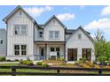 Charming two-story home with gray siding, black windows, and landscaped front yard at 4770 Wayt Farm Overlook, Cumming, GA 30040