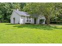 Traditional home showcasing a lush green lawn and beautiful mature trees at 5426 Martins Crossing Rd, Stone Mountain, GA 30088