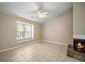 Spacious living room featuring neutral paint, ceiling fan, and fireplace at 5426 Martins Crossing Rd, Stone Mountain, GA 30088