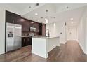 This kitchen features stainless steel appliances, granite counters, dark wood cabinets and an island at 1080 Peachtree Ne St # 804, Atlanta, GA 30309