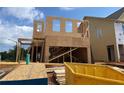Construction site view showing the wood frame of a new two-story home being constructed in a residential area at 120 Winsome Way, Woodstock, GA 30188