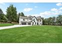 Striking modern home with three-car garage and expansive lawn, surrounded by mature trees at 4292 Sardis Church Rd, Buford, GA 30519