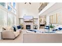 Spacious living room with fireplace, high ceilings, abundant natural light, and stylish modern decor at 297 Aylesbury Blvd, Mcdonough, GA 30252