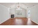 Bright living room with vaulted ceiling, fireplace, and large windows offering an airy and open feel at 3707 Vineyards Lake Nw Cir # 22, Kennesaw, GA 30144