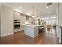 Modern kitchen featuring sleek gray cabinets, quartz countertops, stainless steel appliances, and pendant lighting at 1598 Aldworth Se Pl, Marietta, GA 30339