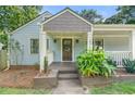 Inviting front porch showcasing the home's entrance and Craftsman details at 1895 Flat Shoals Se Rd, Atlanta, GA 30316