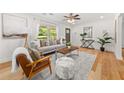 Bright living room featuring hardwood floors, a ceiling fan, and large windows at 1895 Flat Shoals Se Rd, Atlanta, GA 30316