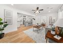 Open-concept living room featuring hardwood floors and seamless flow into the kitchen at 1895 Flat Shoals Se Rd, Atlanta, GA 30316