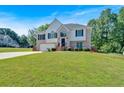 Inviting two-story home featuring a manicured lawn, brick facade, and attached two-car garage at 1331 Red Hill Rd, Marietta, GA 30008